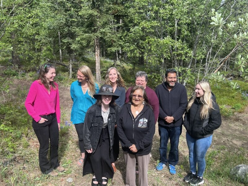 Members of the YSPOR Oversight Committee standing outside in nature in front of a forest